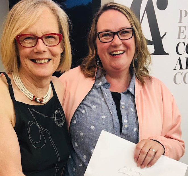 <p>THE ARTS ARE ILLUMINATED – (L-R) AITC board member Sarah Moran presents Krista Dalby with the Community Arts Builder Award at the 26th annual Art in the County opening night. (Facebook photo)</p>
