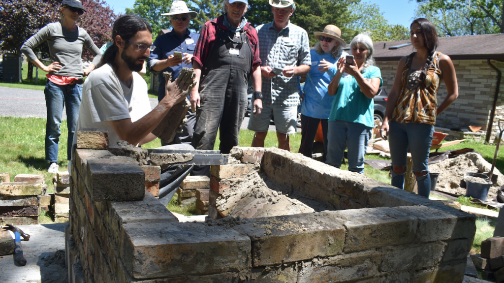 <p>CLAY CREATION- Loyalist College instructor Salvador Santinoli explains the process of building a door on a clay barrel oven at Black River Bed and Breakfast on Saturday afternoon. (Jason Parks/Gazette Staff)</p>

