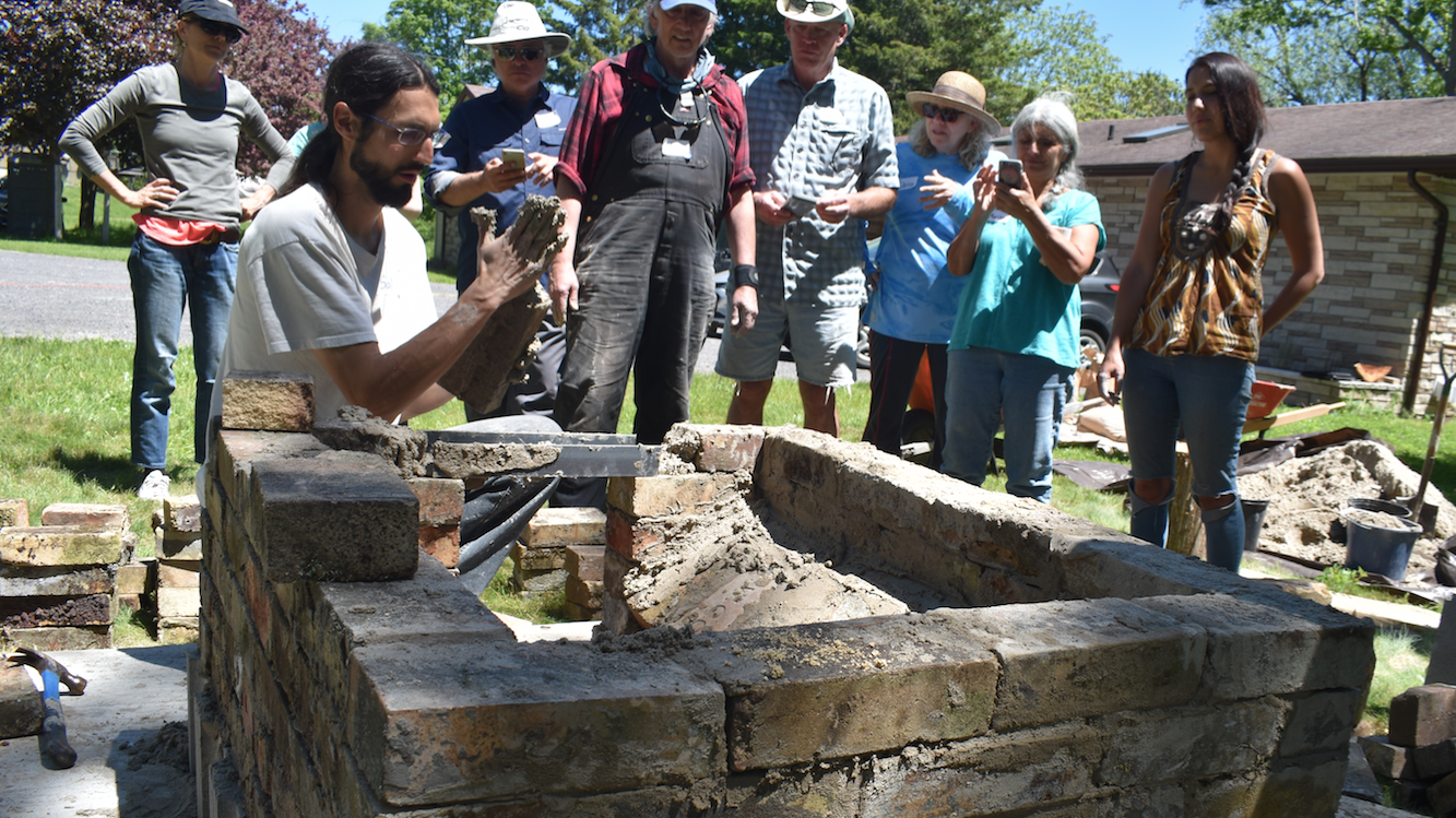 <p>CLAY CREATION- Loyalist College instructor Salvador Santinoli explains the process of building a door on a clay barrel oven at Black River Bed and Breakfast on Saturday afternoon. (Jason Parks/Gazette Staff)</p>
