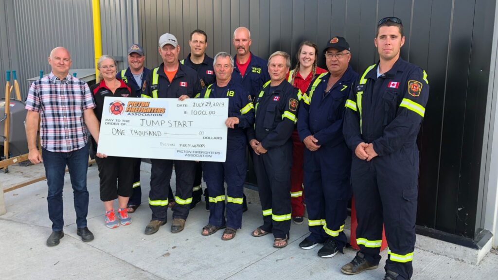 <p>JUMPING FOR JUMPSTART- (From left) Picton Canadian Tire Store owner Jason Quenelle and manager Louise Tolley accept a cheque for $1,000 from Picton Firefighter Association members Jason Young, Steve Everall, Tim Kraemer, Elmer Bentley, John Thiessen, David<br />
Fox, Alison Leavitt, Paul Vidito and Adam Dayton Monday night. The funds will go towards the local Jumpstart initiative. (Jason Parks/Gazette Staff)</p>
