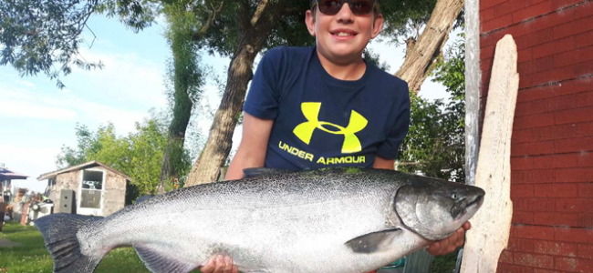 <p>REEL BIG- Ethan Caley and his award winning 28.87 lb Chinook Salmon reeled in near Nicholson Island. (Submitted Photo)</p>
