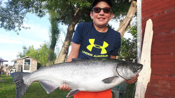<p>REEL BIG- Ethan Caley and his award winning 28.87 lb Chinook Salmon reeled in near Nicholson Island. (Submitted Photo)</p>
