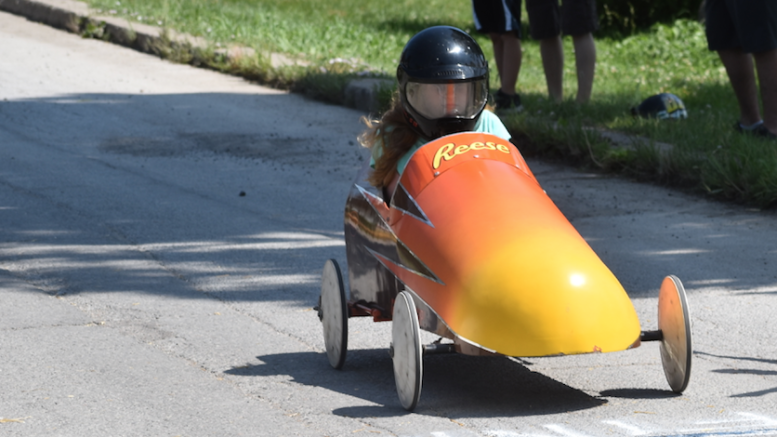 <p>RACER REESE – Age 10-11 Group winner Reese Rowbotham cruises over the finish line at the annual Bloomfield Soap Box Derby on Saturday. Around 50 children participated. (Sarah Williams/Gazette Staff)</p>
