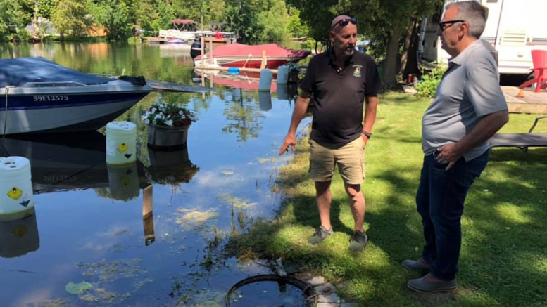 <p>THE TIDE IS HIGH- (From left) Log Cabin Point Resort owner/operator and Athol Councillor Jamie Forrester speaks with then-Bay of Quinte MP Neil Ellis in   2019. (Submitted Photo)</p>
