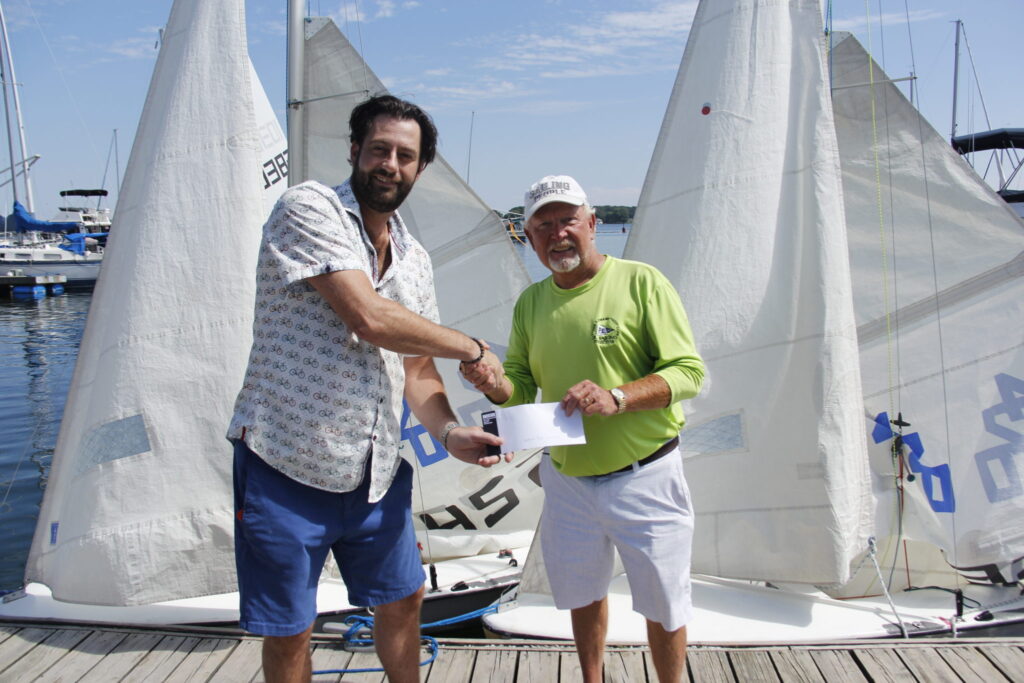 <p>SAILING ON Micheal Hymus, owner of Angry birds restaurant is handing Jr. Sailing Director Robert Quaiff a cheque for the remainder of what he donated towards The Prince Edward Yacht Club Junior Sailing camps. Thanks to all the donations received the programs numbers in attendance hit an all time high as they maxed out for the first time in over 40 years the programs have been in operation. (Desirée Decoste/Gazette Staff)</p>
