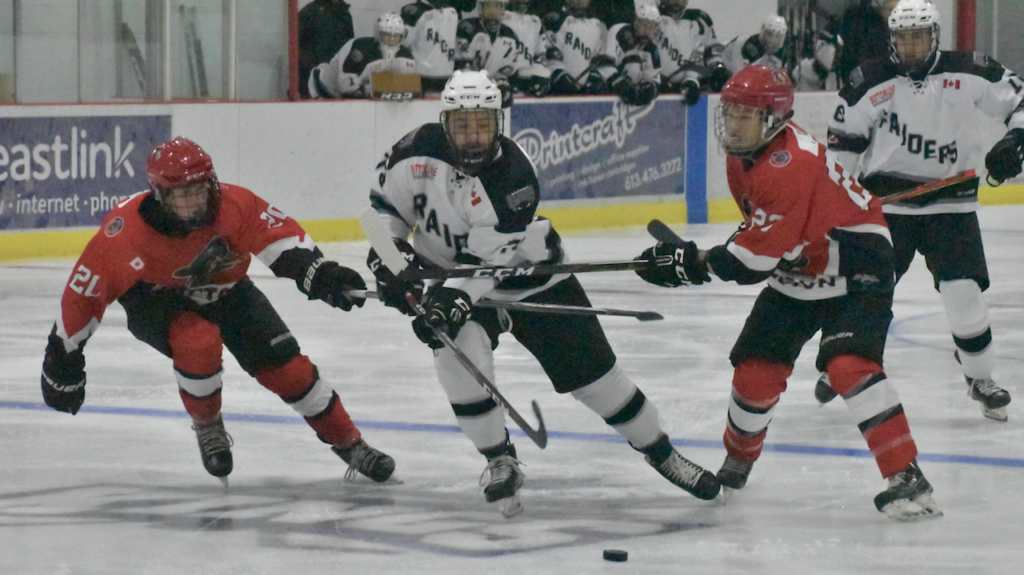 <p>BUSTING THROUGH- Napanee Raider Aidan McFarland tries to escape the checking of Brayden Adams and Matt Poole at Huff Estates Arena Thursday night. McFarland had a pair of goals for the visitors who topped Picton 4-2 (Jason Parks/Gazette Staff)</p>
