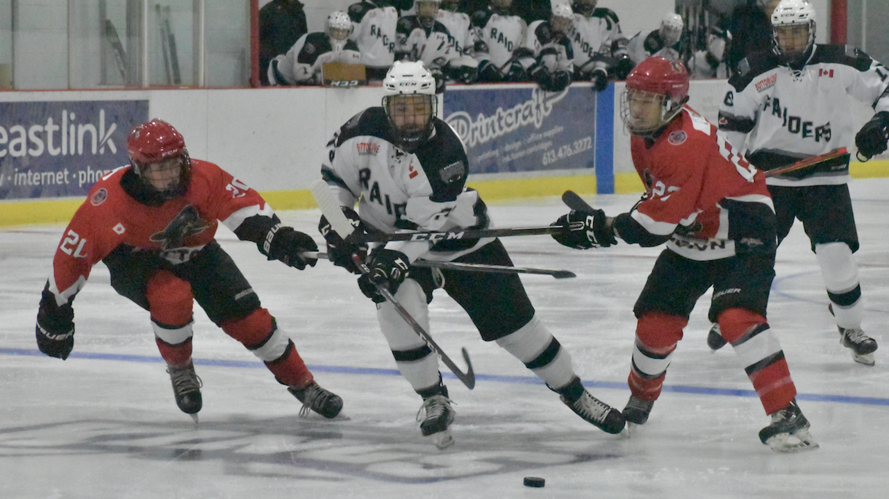 <p>BUSTING THROUGH- Napanee Raider Aidan McFarland tries to escape the checking of Brayden Adams and Matt Poole at Huff Estates Arena Thursday night. McFarland had a pair of goals for the visitors who topped Picton 4-2 (Jason Parks/Gazette Staff)</p>
