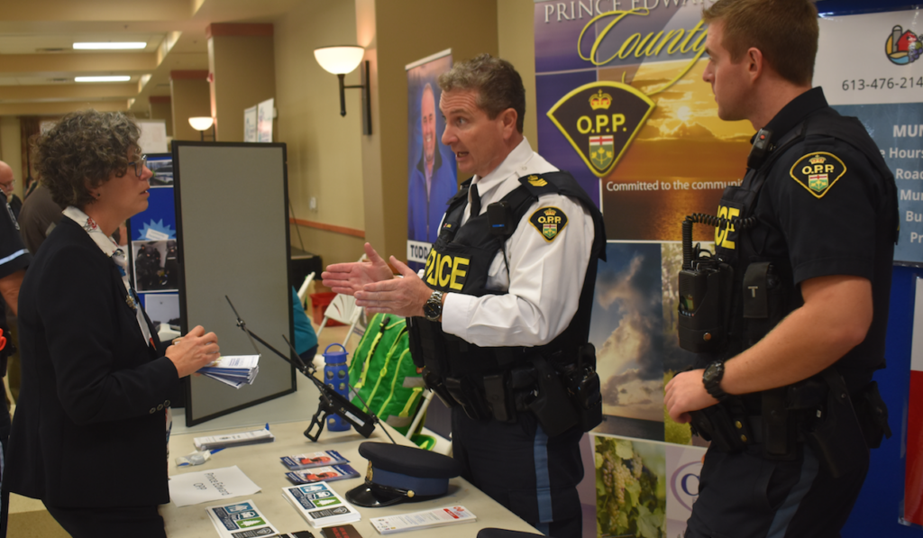 <p>(RIght) Community Services Officer Constable Aaron Miller with Prince Edward Detachment Commander John Hatch provide information to a member of the public at the Senior’s Fair last fall. (Jason Parks/Gazette Staff)</p>
