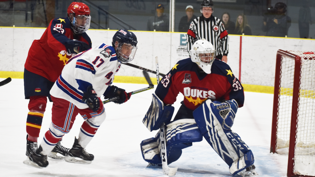 <p>Defenceman Noah Massie clears North York captain Tyler Flack the front of his net on Thursday evening. Massie and (right) Wellington netminder Matthew Dunsmoor picked up a point in a 4-4 tie. (Jason Parks/Gazette Staff)</p>
