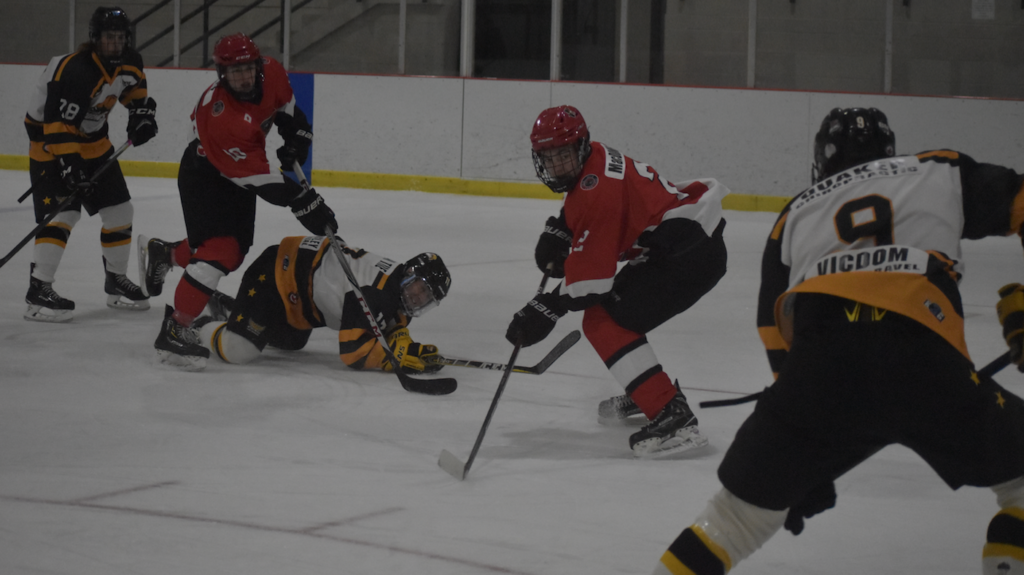 <p>TURNING POINT- A prone Toby Cooper slides the puck to an awaiting Josh Cammalleri as Picton’s Jacob Dietz and Aiden MacDonnell look on. Cammalleri would score the game winning goal on the play in Uxbridge’s 3-1 win Saturday night. (Jason Parks/Gazette Staff)</p>
