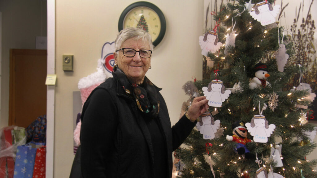<p>ANGELS AMONG US Children’s Foundation Angel Tree organizer Susan Rose with one of several angels still hanging on the tree at the campaign office in 2019. (Desirée Decoste/Gazette Staff)</p>
