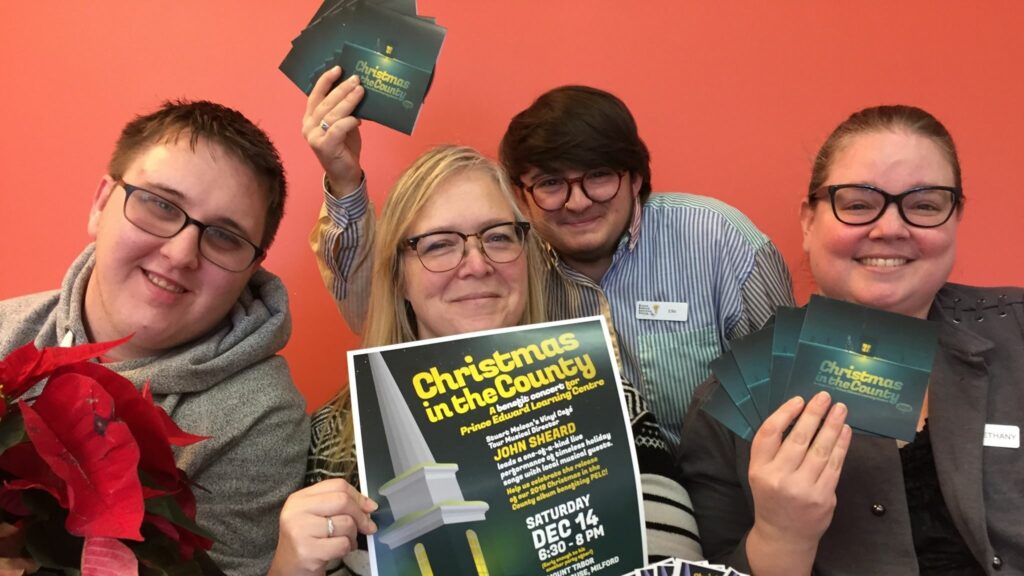 <p>REASON TO SMILE  – (L-R) Bradley O’Neil, Lori Farrington, Ellis Greenberg and Bethany MacInnes pose with copies of the 2019 Christmas in the County album and a poster for the accompanying Mt. Tabor event. (Submitted Photo)</p>
