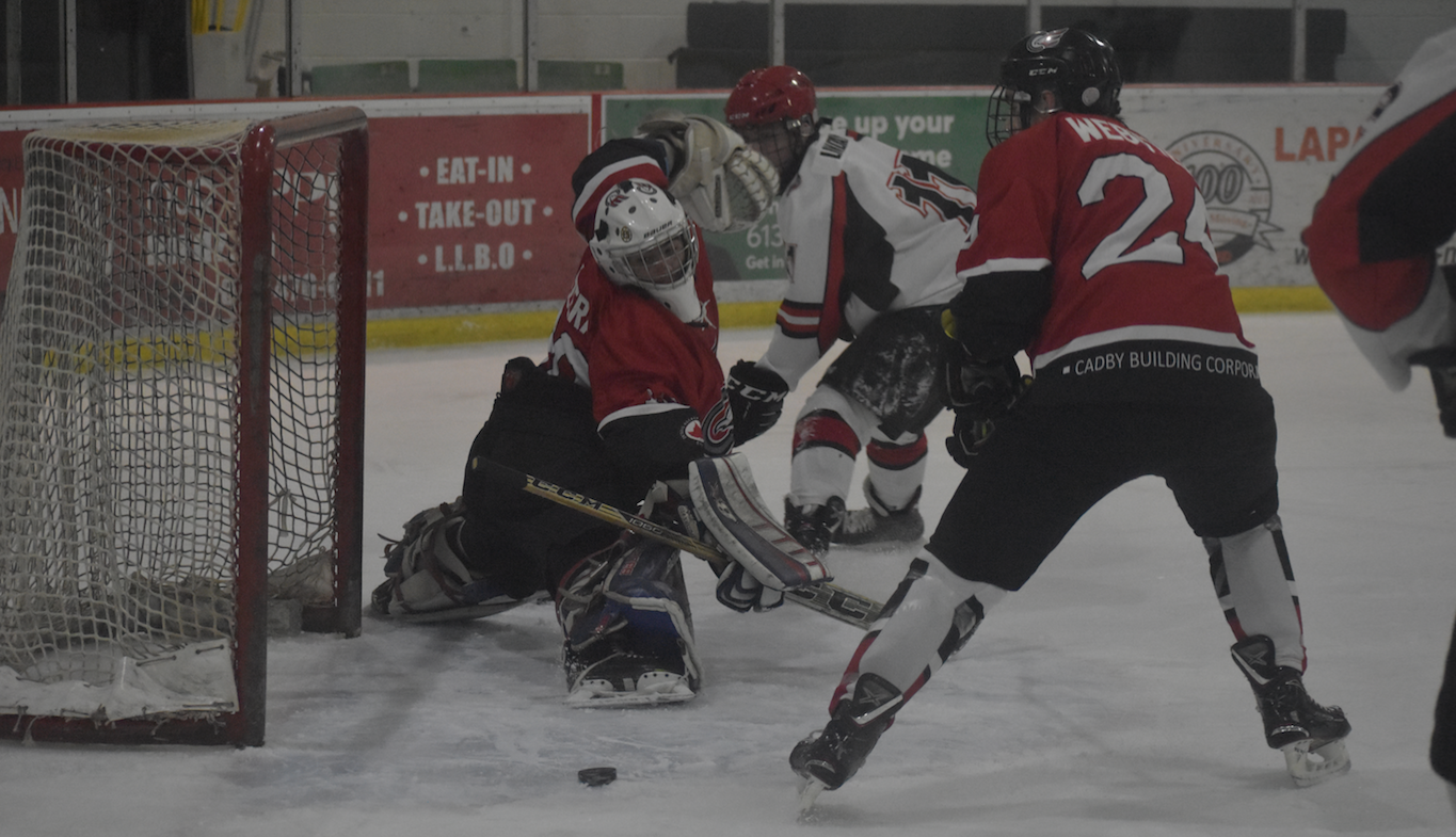 <p>SERVING IT UP With Picton Pirate Dawson Lindsay on the hunt for a rebound, Clarington Eagles goaltender Alex Lapizzera makes an acrobatic save. at Huff Estates Arena Tuesday night.  The Pirates came back on the visitors in a 4-3 win, the club’s 16th victory in 18 games. (Jason Parks/Gazette Staff)</p>

