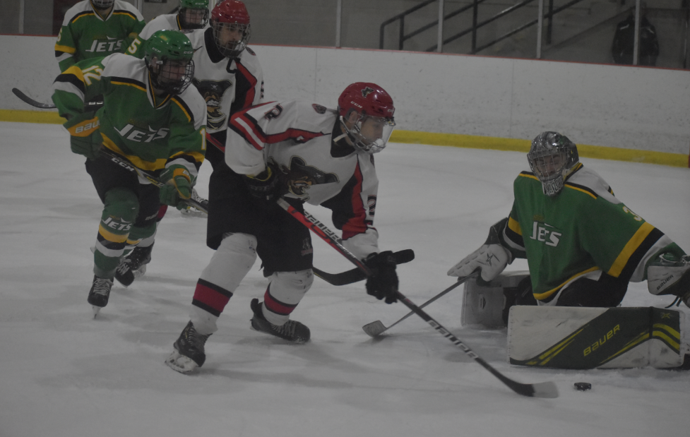 <p>ON THE HUNT- Picton’s Nick Kirby-Palliser tries to lift the puck over Amherstview Jets goalie Brady Sarazin. The Pirates downed the visiting Jets 5-3 Thursday night. (Jason Parks/Gazette Staff)</p>
