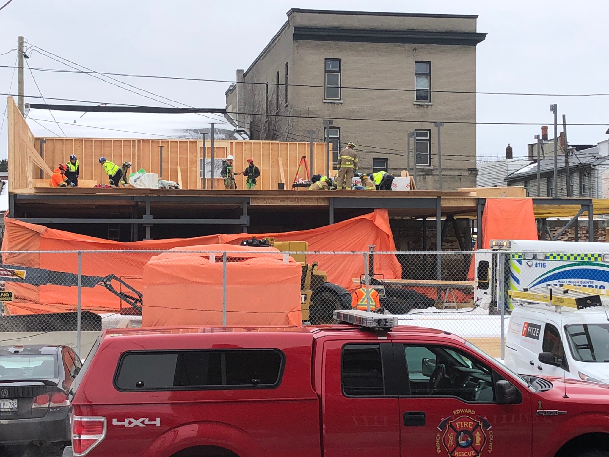 <p>Rescue workers and paramedics attend to two fallen workers on the second level of a building under construction on Ross St. Tuesday morning. (Jason Parks/Gazette Staff)</p>
