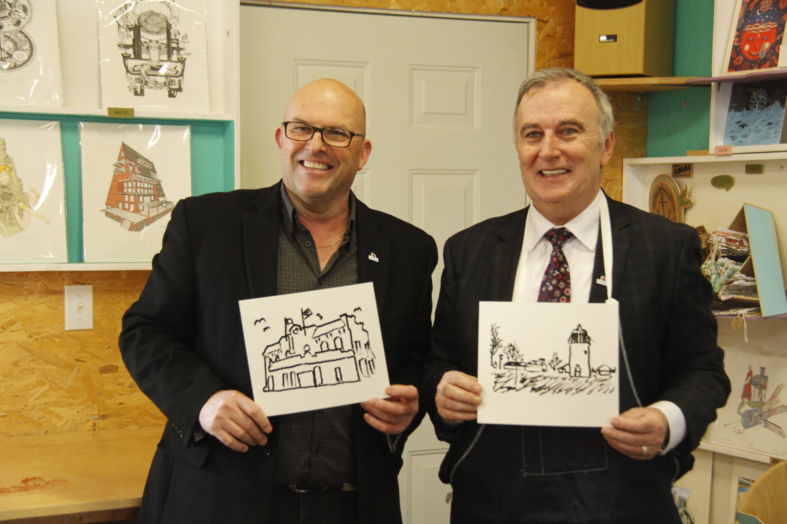 <p>ARTISTS OF THEIR OWN<br />
(left) Mayor Steve Ferguson and (right) Member of Parliament for Bay of Quinte Neil Ellis stood proud with their prints they drew themselves at the announcement of $300,000 is being invested for Prince Edward County off-season tourism at Spark Box Studio on Friday. (Desirée Decoste/Gazette Staff)</p>
