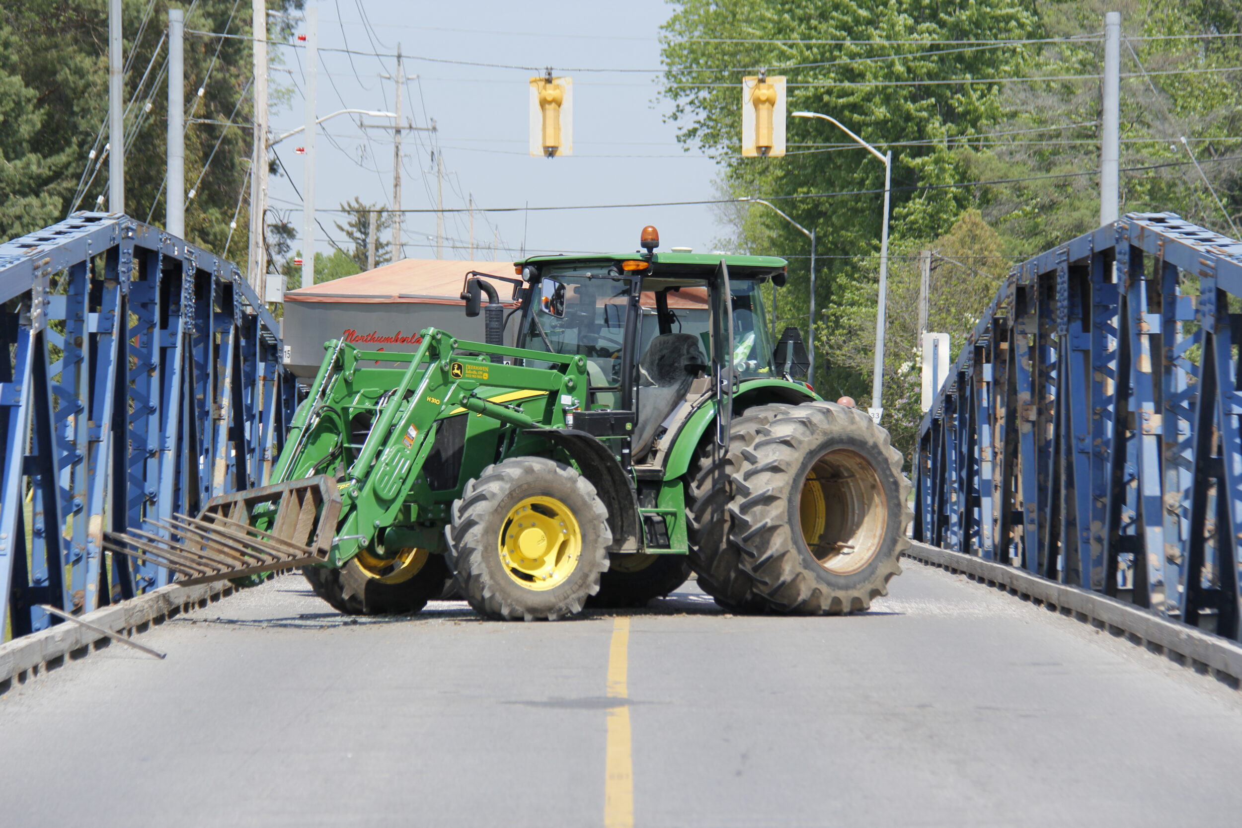 <p>A farm tractor pulling a fertilizer spreader jack knifed at the Carrying Place bridge around noon on Wednesday. An  engineer from Parks Canada, the federal body that maintains and operates the swing bridge will need to inspect for any damage prior to the bridge’s reopening. Motorists are advised to find an alternate route as the estimated time for reopening is unknown.(Desirée Decoste/Gazette Staff)</p>
