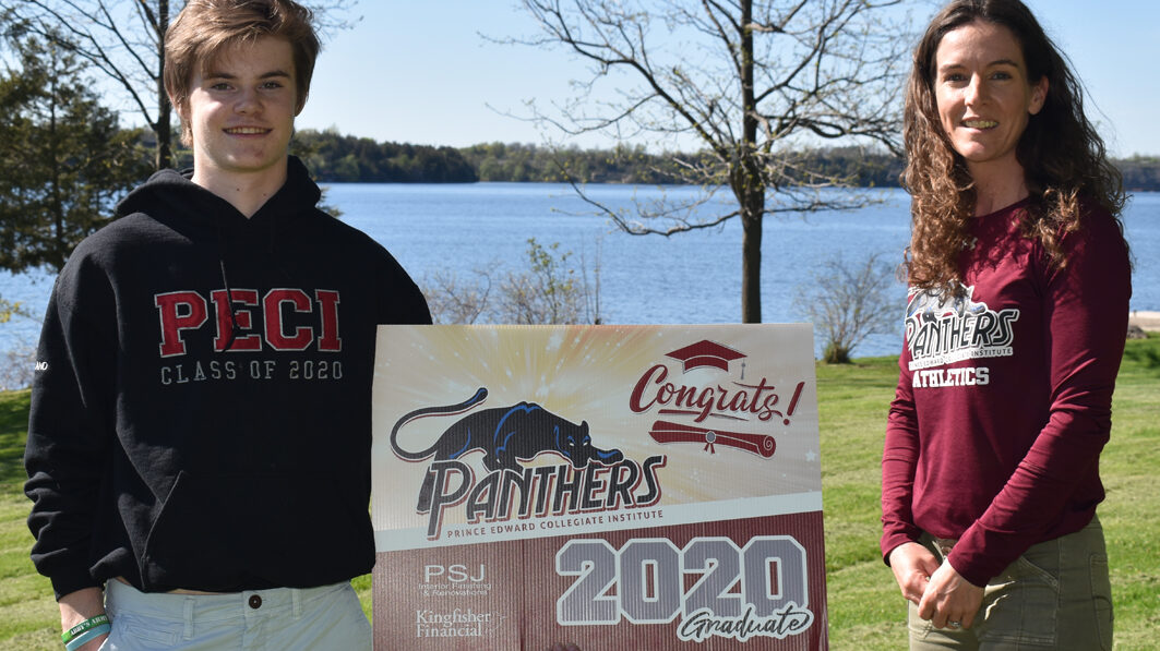 <p>GRADUATION DAY 2020 PECI graduate Case McFarland accepts a graduate lawn sign from school Athletic Director Laurie Spencer last week. The COVID-19 pandemic erased any hope of a traditional late June graduation ceremony but hopes are the grads will return on Thanksgiving for a celebration. (Jason Parks/Gazette Staff)</p>
