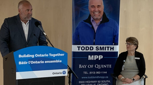<p>NEW FUNDING  MPP Todd Smith speaks at a recent QHC meeting while CEO and President Mary Clare Egberts looks on.  (Submitted Photo)</p>
