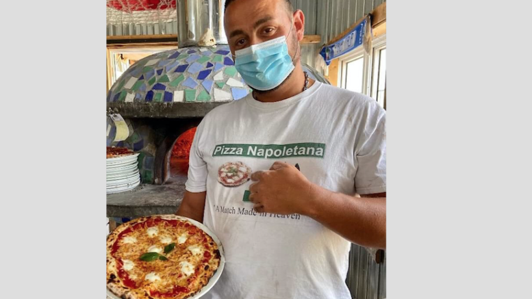 <p>SERVED UP HOT Terracello’s Tony Auciello shows off his Margherita pizza, one of several pies Emmy Award winner Toni Collette tasted during her visit to the winery on Saturday.   (Submitted Photo)</p>
