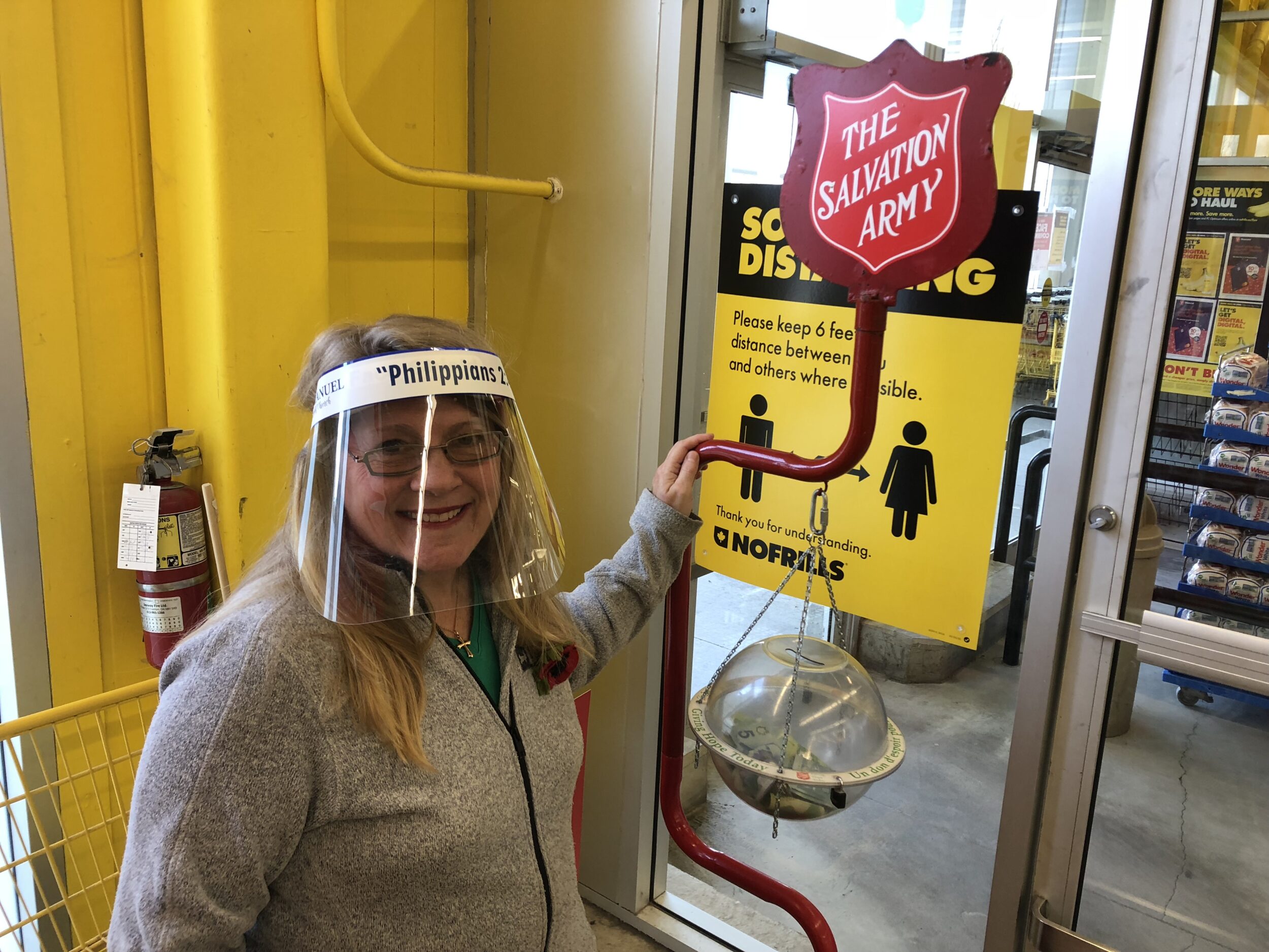 <p>Salvation Army Kettle Campaign volunteer Beverly Busch stands beside a kettle at Andrew and Emily’s No Frills on Friday. COVID-19 has negatively impacted the Salvation Army’s volunteer base. (Jason Parks/Gazette Staff)</p>
