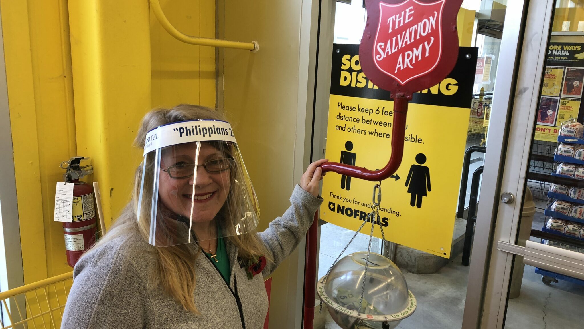 <p>Salvation Army Kettle Campaign volunteer Beverly Busch stands beside a kettle at Andrew and Emily&#8217;s No Frills on Friday. COVID-19 has negatively impacted the Salvation Army&#8217;s volunteer base. (Jason Parks/Gazette Staff)</p>
