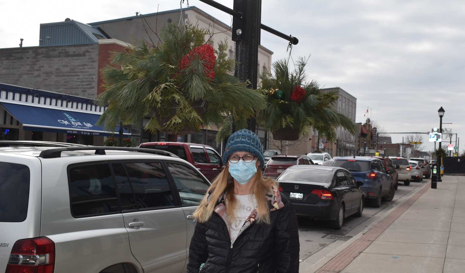 <p>BEWARE- Local woman Ingrid Pierson stopped by the Gazette office last week to speak about her 2019 collision with a hanging flower pot on Main Street. When the Gazette inquired to the municipality about the matter, the County of Prince Edward removed the baskets and stated they would be working with the Picton BIA on a solution. (Jason Parks/Gazette Staff)</p>
