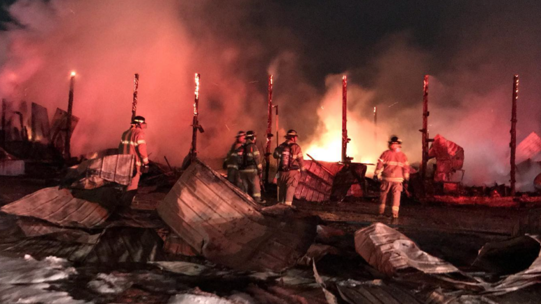 <p>Prince Edward County Fire Fighters work on a fire at Sunset Farms and Cabins in Northport on Wednesday evening.  (Facebook photo)</p>
