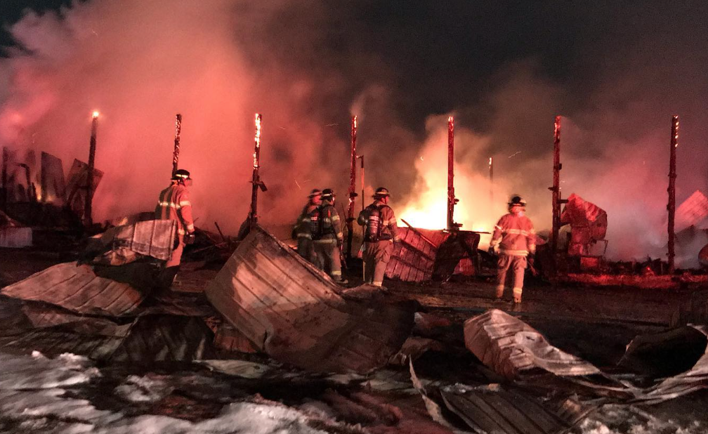 <p>Prince Edward County Fire Fighters work on a fire at Sunset Farms and Cabins in Northport on Wednesday evening.  (Facebook photo)</p>
