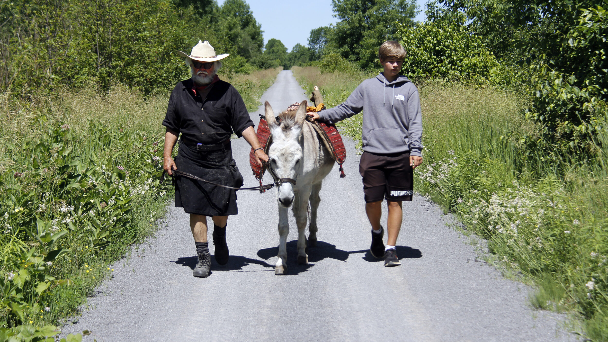 <p>ONE WAY TREK Storyteller Conrad Beaubien (left) with son Luke (right) took to the Millennium Trail once again with Thunder the donkey Sunday for Walking with Thunders one way 6 km walk from Smokes Point Road to Salem Road. (Desirée Decoste/Gazette staff)</p>
