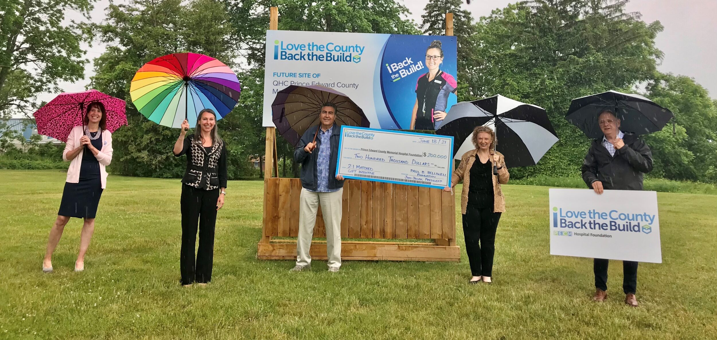 <p>SINGING IN THE RAIN (From Left) Stacey Daub, QHC president and CEO; Shannon Coull, executive director of the PECMH Foundation; John Jenah, president of the Paul B. Helliwell Foundation; Barbara McConnell, chairperson of the PECMH Foundation and Dennis Darby, Back the Build campaign co-chairperson and PECMHF board member celebrate the announcement of the Helliwell Foundation offering to match Back the Build Campaign donations at a 2:1 ratio. (Submitted Photo)</p>

