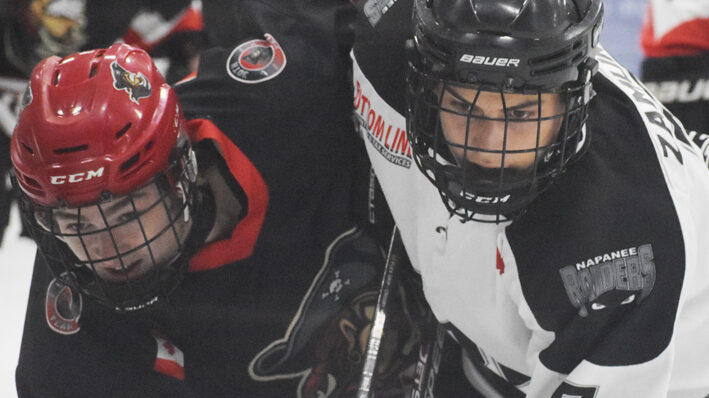 <p>FOREVER RIVALS Picton’s Landon MacLellan and Napanee’s Soren Zamuner battle off the draw during the Raiders’ 2-1 overtime win Friday.  (Gazette Staff)</p>

