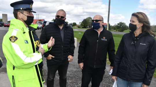 <p>ON SCENE (From Left) Prince Edward OPP Detachment Commander John Hatch speaks with MPP Todd Smith, Mayor Steve Ferguson and Minister of Transportation Caroline Mulroney about the issues at the Highway 62/County Road 1 intersection. (Submitted Photo)</p>
