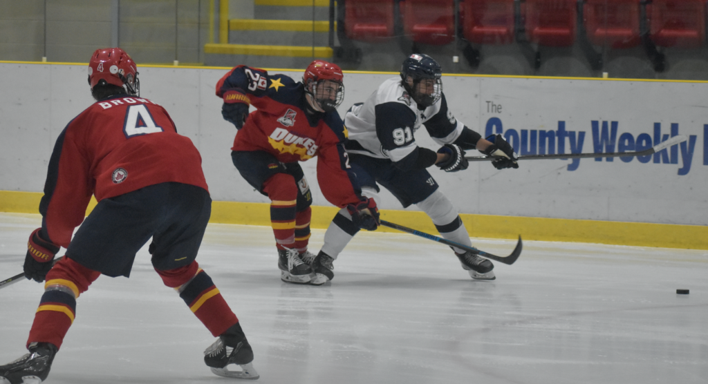 <p>Haliburton’s Nick Anthanasakos tries to get past Cam Kosurko during Wellington’s 5-1 win Friday night. (Jason Parks/Gazette Staff)</p>
