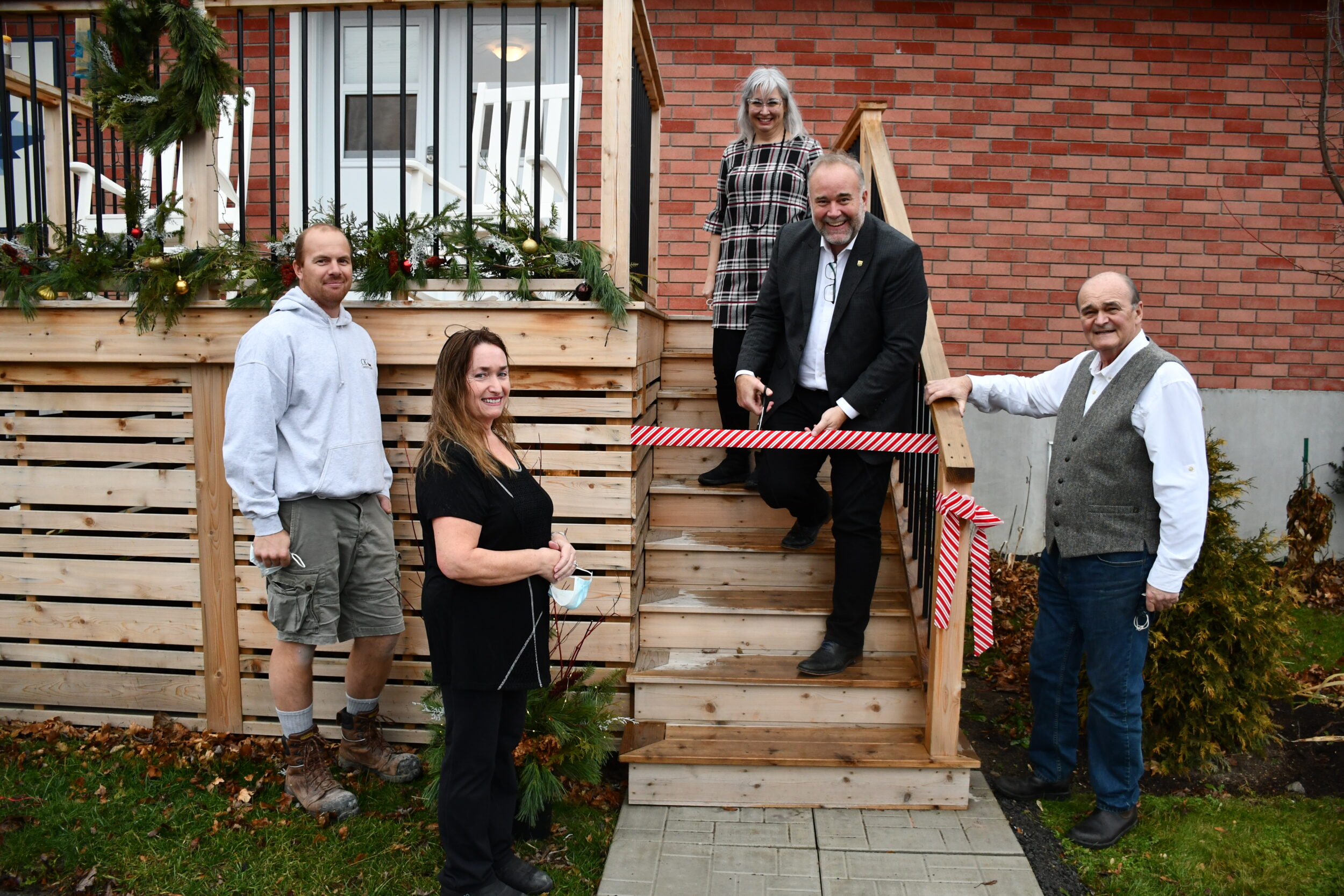 <p>OUTDOOR SPACE- (CENTRE) Bay of Quinte MPP Todd Smith cuts the ribbon on a new entry way  funded by the Ontario Trillium Foundation. Smith is flanked by (From Left) builder Chris Koopmans, Hospice’s Karen Mayer, Melanie Daley and Peter Matthewman. (Submitted Photo)</p>
