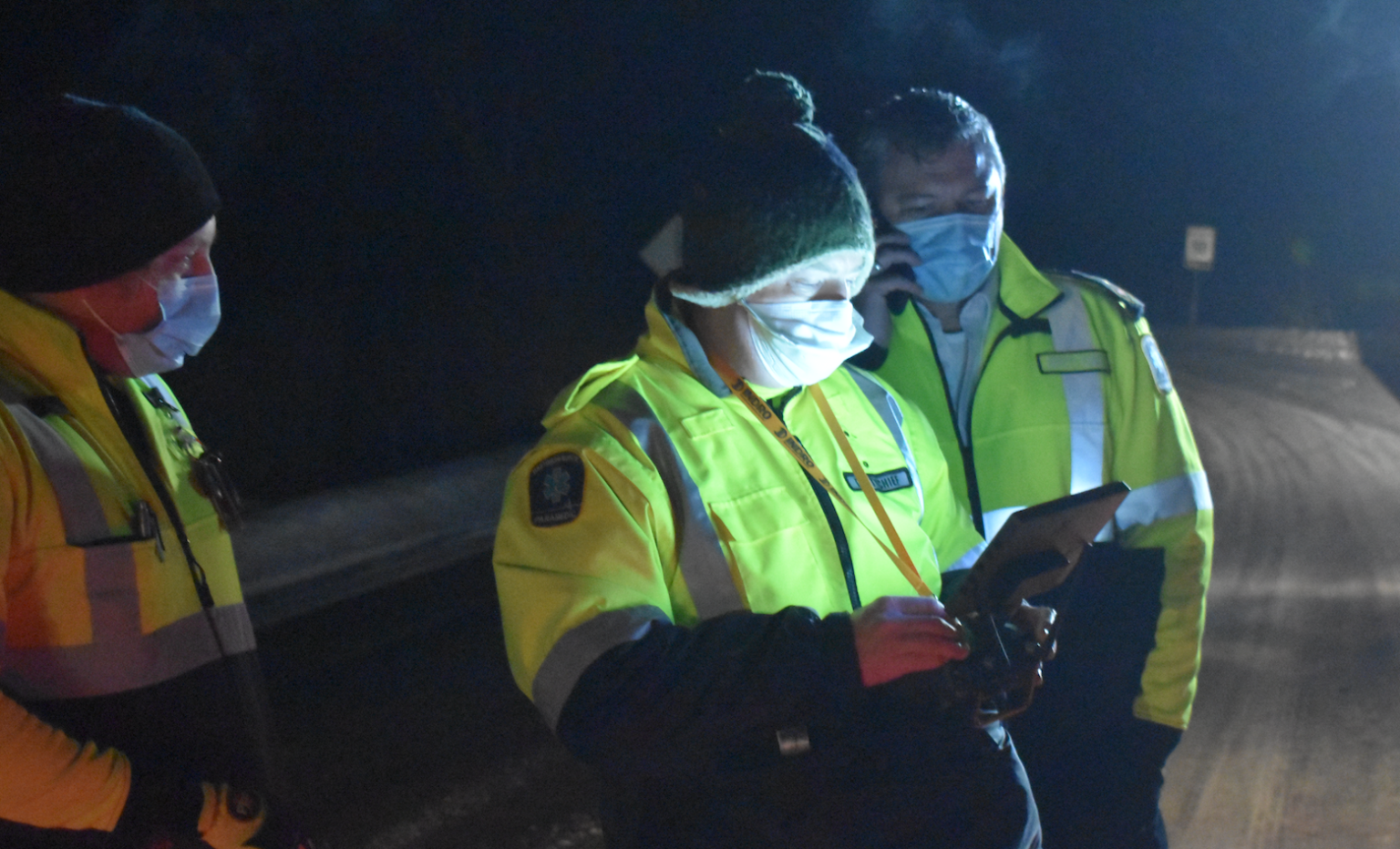 <p>Members of Hastings Quinte Paramedic Services watch a screen as a thermal imaging drone flies high above the Dunes on Monday night. (Jason Parks/Gazette Staff)</p>
