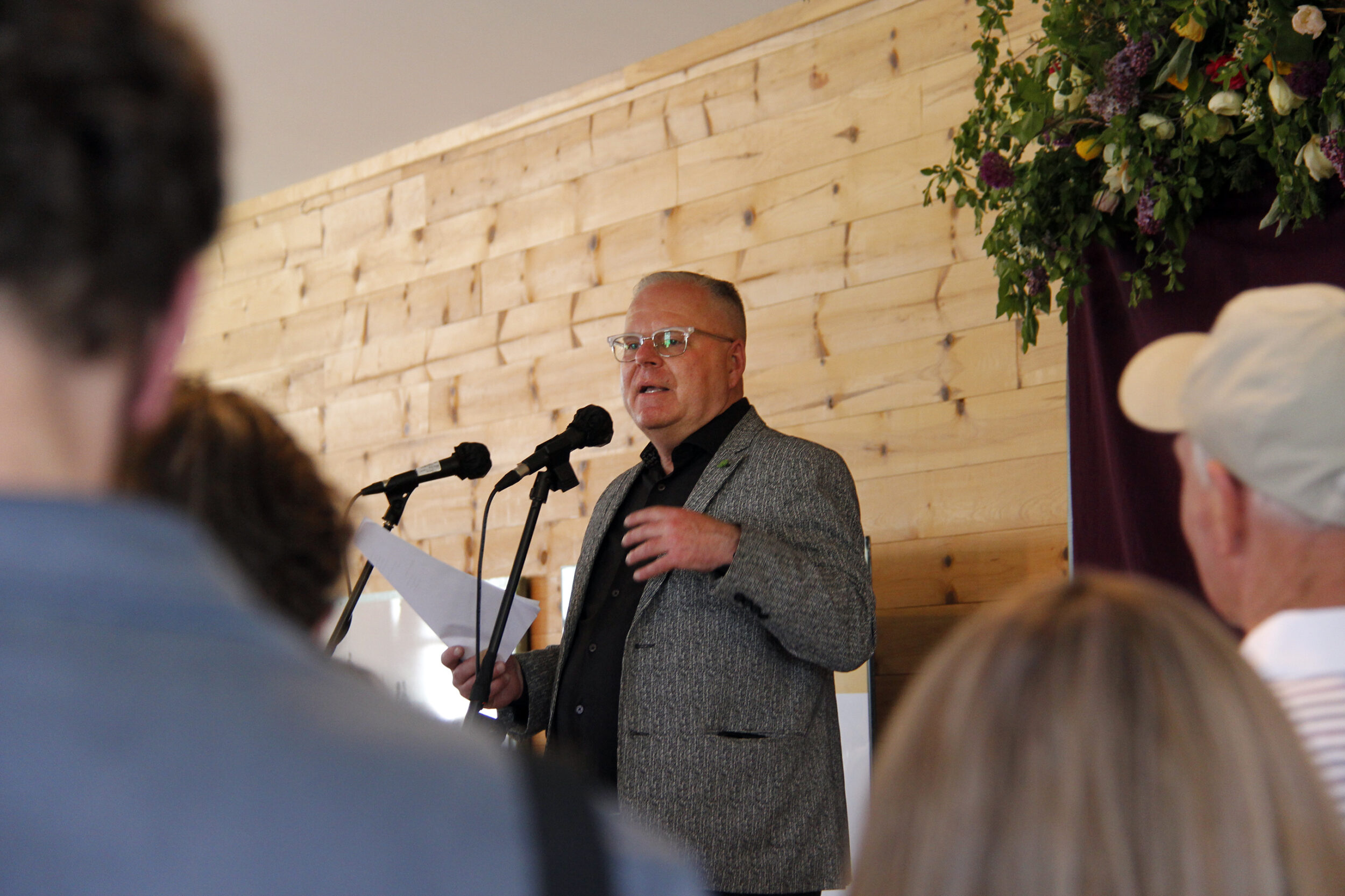 <p>BACK TO THE FUTURE-PEC Community Partner Tim Jones speaks to a large crowd, positioning Base 31 as integral to both the past and future of Prince Edward County. (Desirée Decoste/Picton Gazette)</p>
