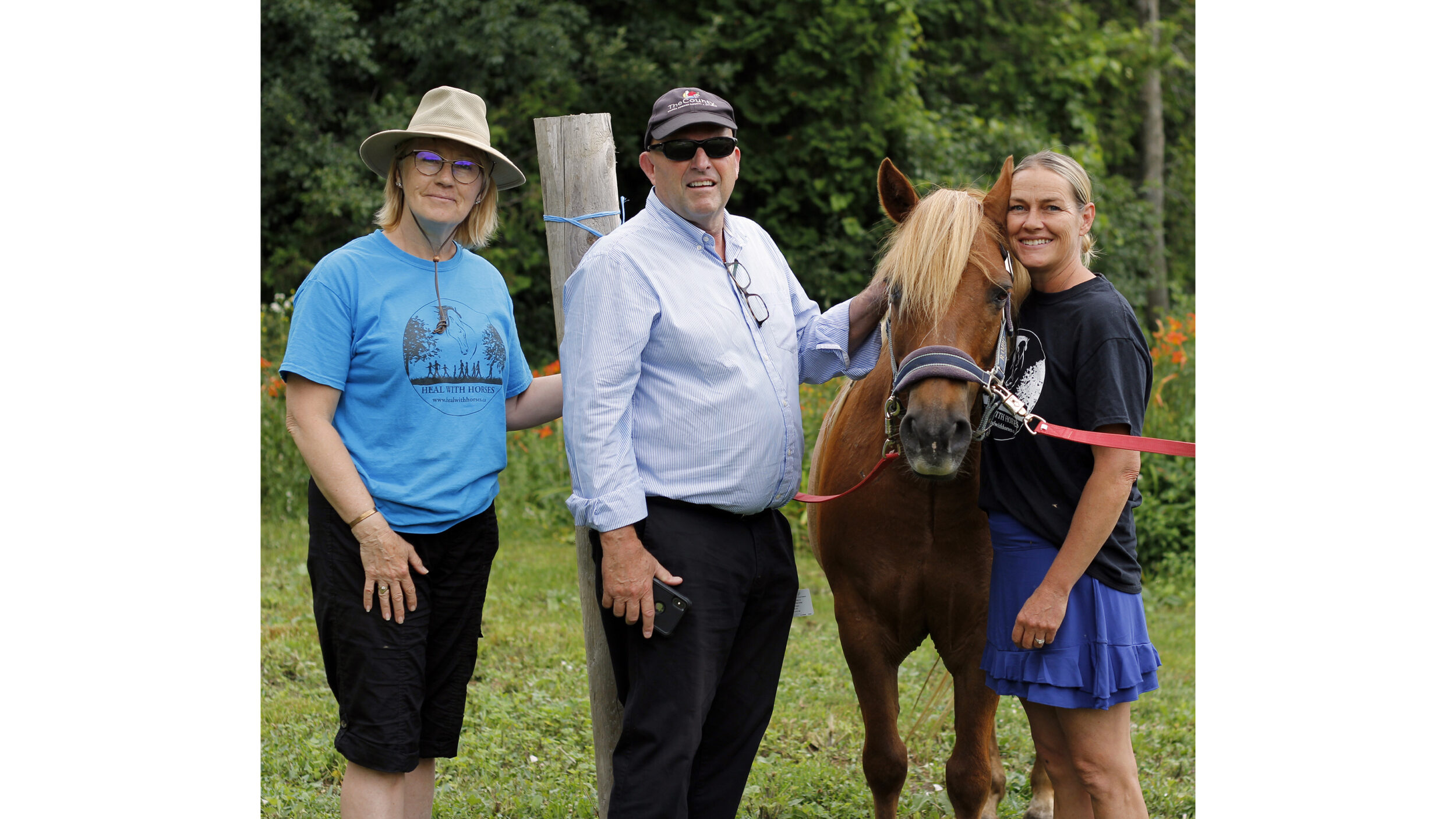 <p>CLOSE CONNECTION (left) Doreen Refuse Westall, Development Director at Heal with Horses, Prince Edward County Mayor Steve Ferguson and Suzanne Latchford-Kulker, Founder and Executive Director of Heal with Horses posed with one of the 15 horses on site as part of the tour for mayors last week. (Desirée Decoste/Gazette staff)</p>

