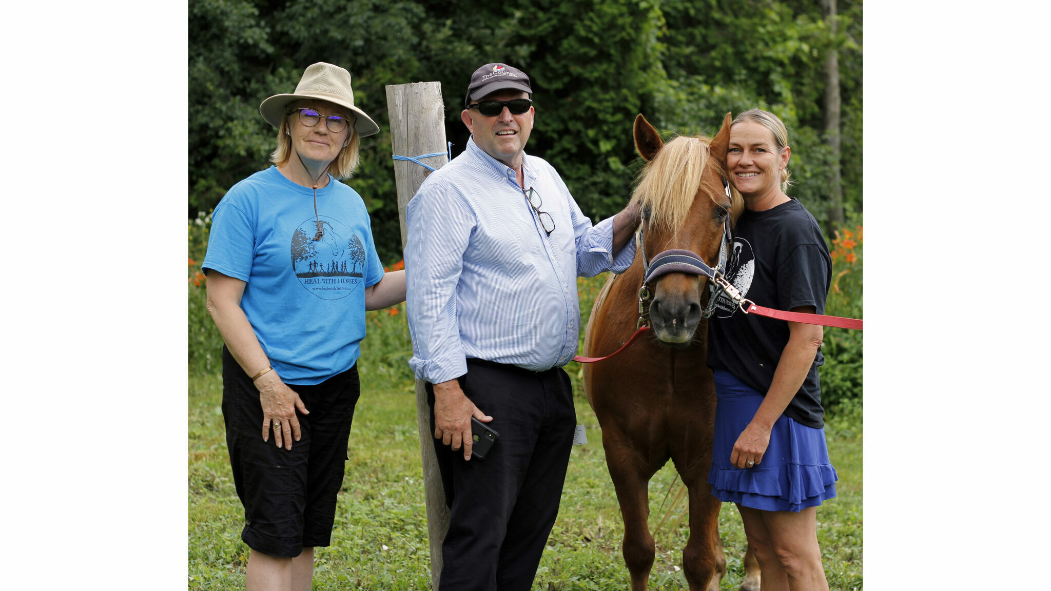 <p>CLOSE CONNECTION (left) Doreen Refuse Westall, Development Director at Heal with Horses, Prince Edward County Mayor Steve Ferguson and Suzanne Latchford-Kulker, Founder and Executive Director of Heal with Horses posed with one of the 15 horses on site as part of the tour for mayors last week. (Desirée Decoste/Gazette staff)</p>

