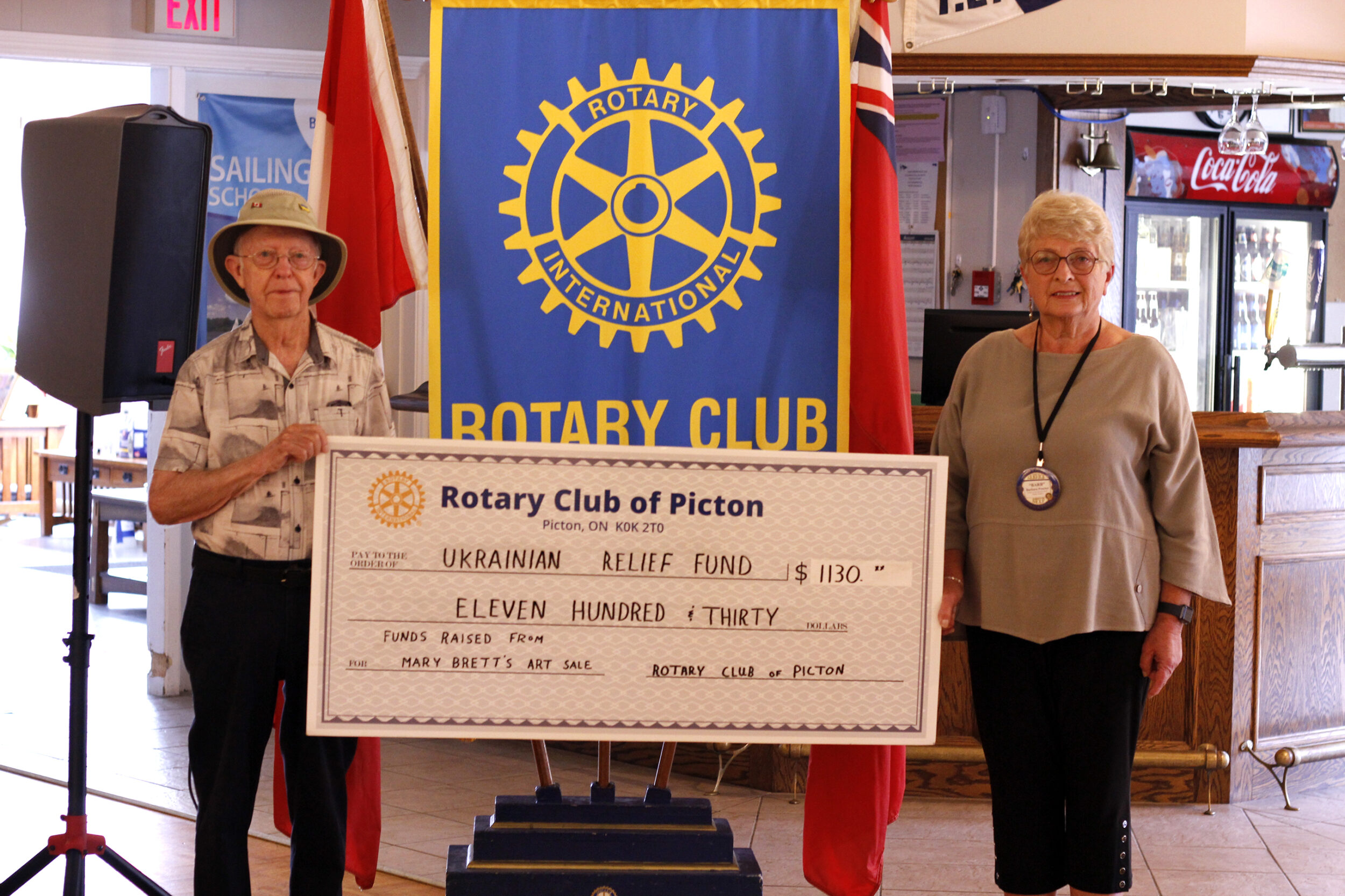<p>(right) Barb Proctor, president of the Picton Rotary Club accepted a donation from (left) David Gilbert of $1,130 to go towards the Ukrainian Relief Fund. Funds raised were through an art show/sale. (Desirée Decoste/Gazette staff)</p>
