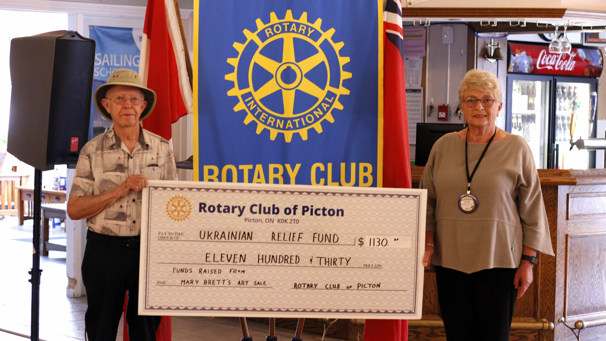 <p>(right) Barb Proctor, president of the Picton Rotary Club accepted a donation from (left) David Gilbert of $1,130 to go towards the Ukrainian Relief Fund. Funds raised were through an art show/sale. (Desirée Decoste/Gazette staff)</p>

