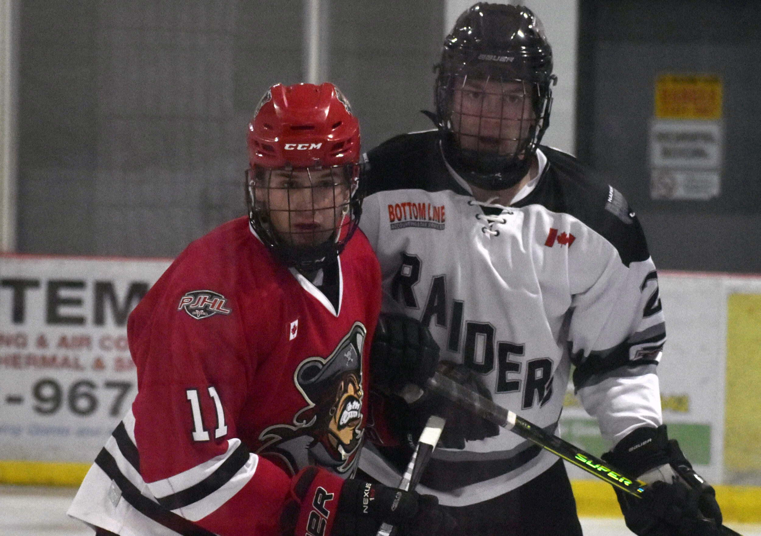 <p>Picton’s Ryan Bauder and Napanee’s Adam Nuttall jostle during the Raider’s 6-3 win over the Pirates Thursday (Gazette Staff)</p>
