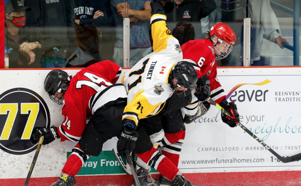 <p>Picton’s Parker Mattis and Caleb Martin interrupt Jacob Tinney during the Pirates’ 5-1 win in Frankford on Saturday night.<br />
(Amy Deroche/Deroche Sports Photography)</p>
