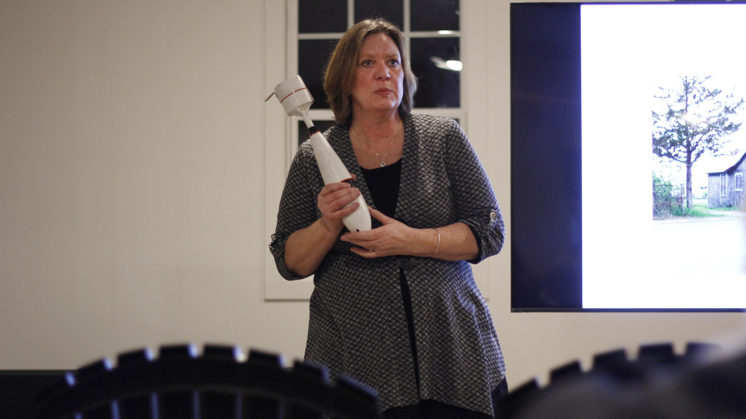 <p>Base31 tour guide Jacqui Burley holds one of the WWII-era paint bombs used by students at the no. 31 bombing and gunnery school. (Desirée Decoste/Gazette staff)</p>

