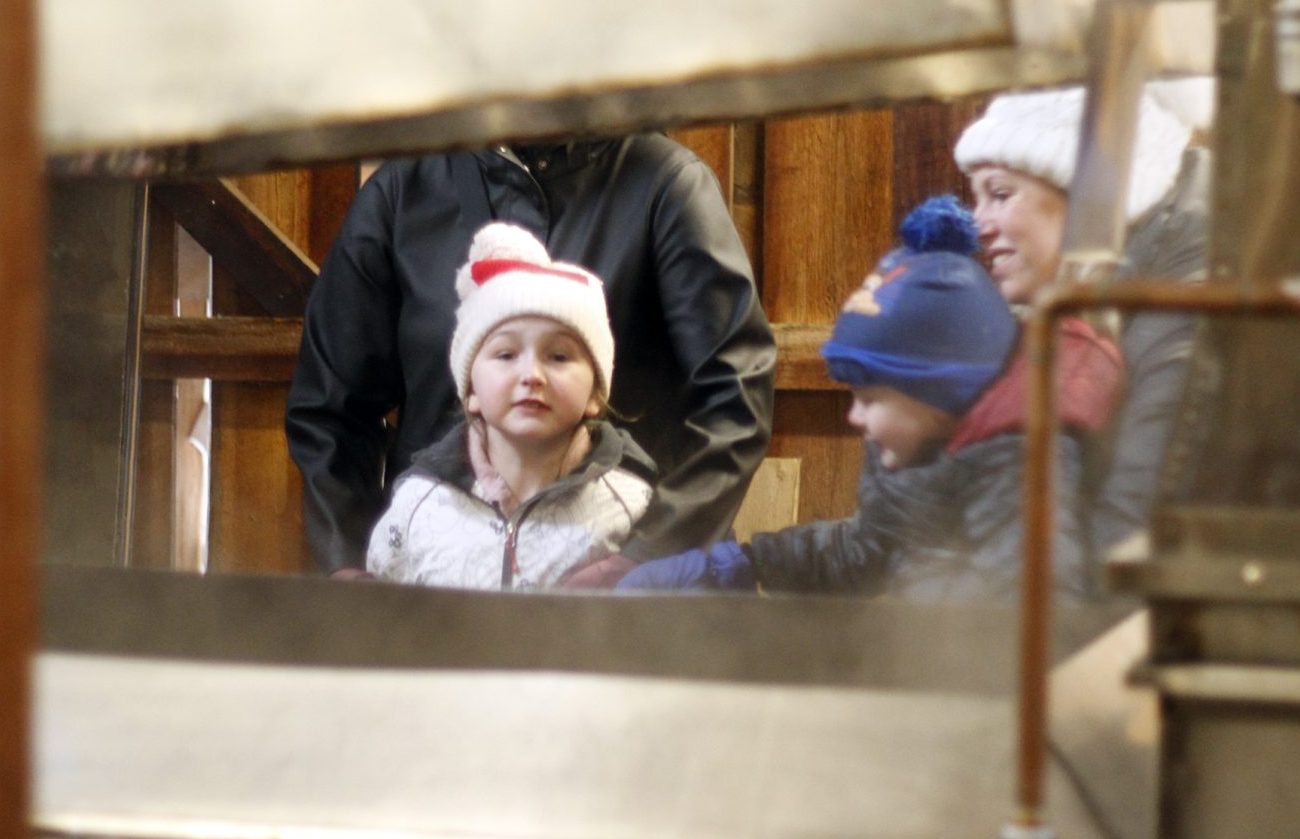 <p>Grace Nadeau peers through the steam at LOHA Farms on Saturday. After a three year hiatus, Maple in the County returned this weekend. (Desirée Decoste/Gazette Staff)</p>
