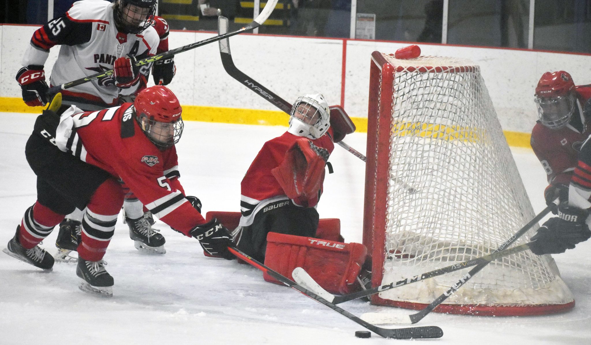 <p>Brady Spry stretches across the goal line as Picton defenders Trot Davis and Rheydan McCoy try to thwart a Port Hope Panthers scoring chance in Game 4 Wednesday night. (Gazette Staff)</p>
