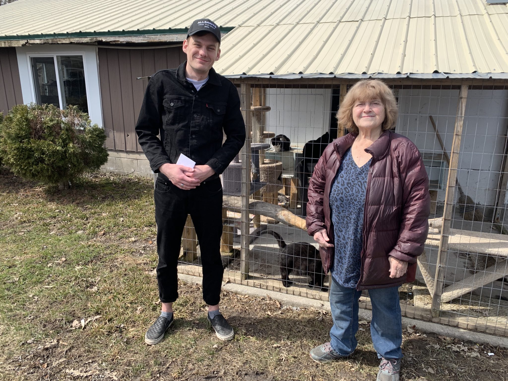 <p>Film maker Carter Purtelle presents proceeds from a screening of his Ascending the Void documentary to Gail Robinson of the Loyalist Humane Society. (Jason Parks/Gazette Staff)</p>
