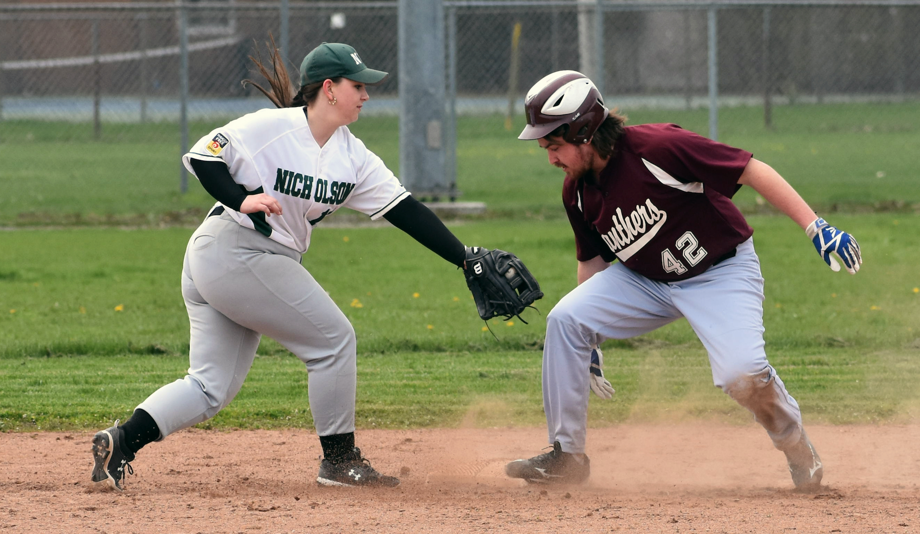 <p>PECI&#8217;s Nathan Steen is safe in a cloud of dust after sending a double to the fence in an 11-2 win over visiting Nicholson Friday. (Jason Parks/Gazette Staff)</p>
