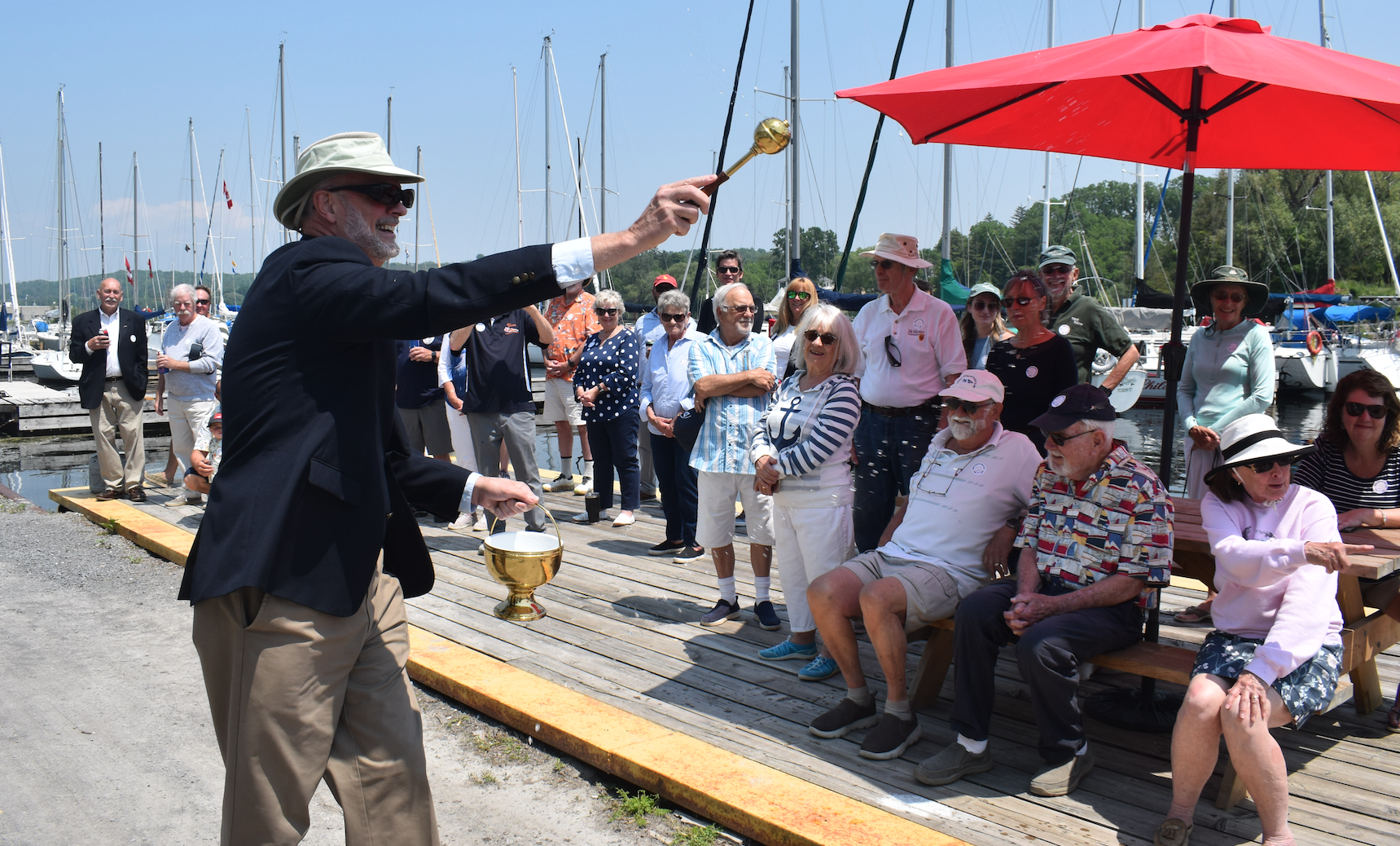 <p>PEYC Chaplain Charles Morris ensures he spreads the blessing afar at the club’s annual sail past event Saturday, June 10. The PEYC is celebrating its 85th anniversary this season. (Jason Parks/Gazette Staff)</p>

