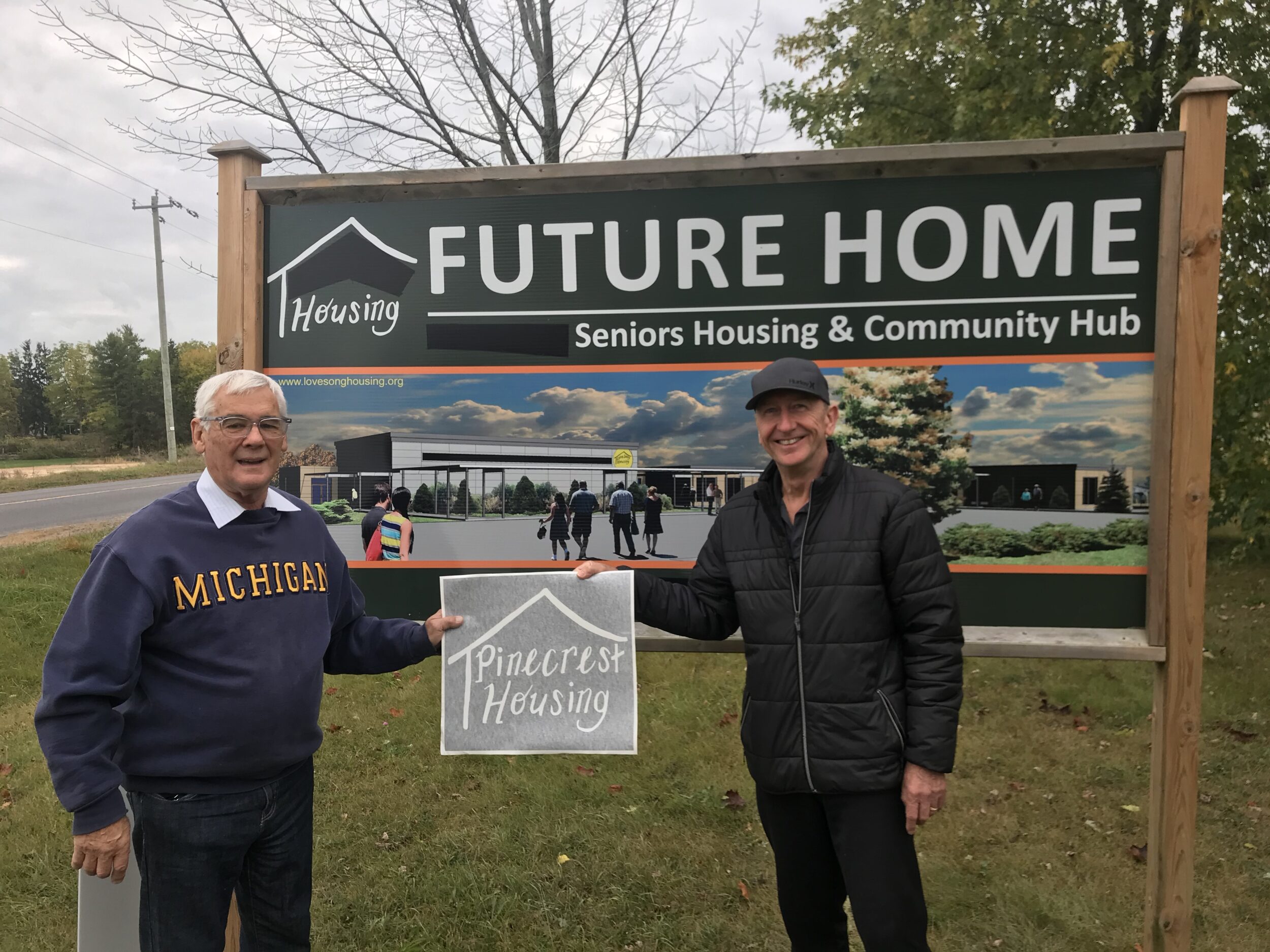 <p>NAMING RIGHTS- (From left) Ken How and Graham Chapman reveal the new name of a housing development and community hub in Bloomfield. (Submitted Photo)</p>
